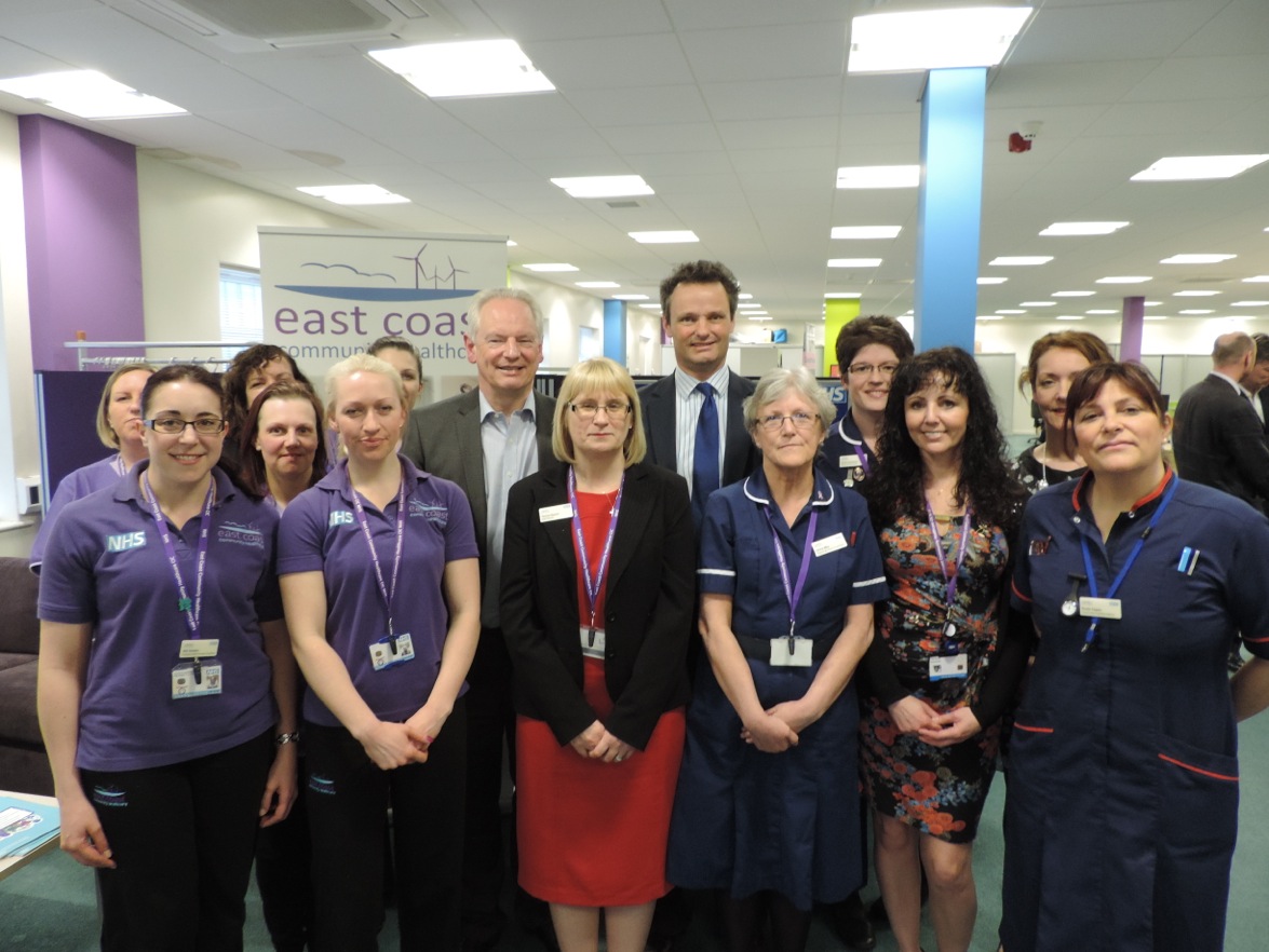 Francis Maude visiting ECCH HQ posing for picture with staff