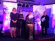 ECCH’s Macmillan Community Cancer Matrons standing on a stage recieving the Norfolk Care Award for Excellent People Centred Care and Support.
