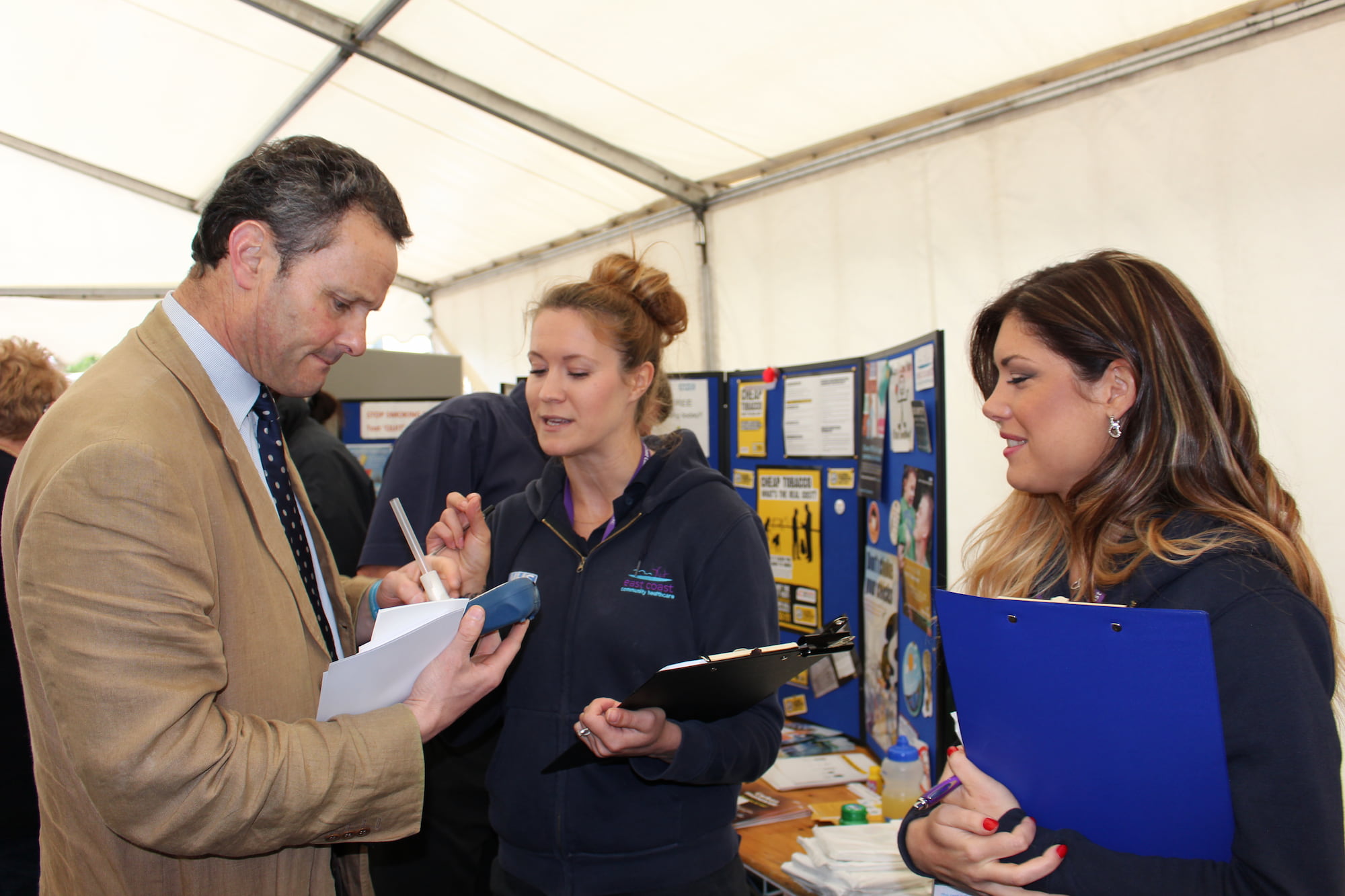 Two ECCH Stop smoking advisors talking to Peter Aldous MP at a smokefree event.