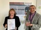 ECCH’s Executive Director of Quality Dr Noreen Cushen-Brewster and Physiotherapost David Sweeting posing with their award infront of their winning research poster