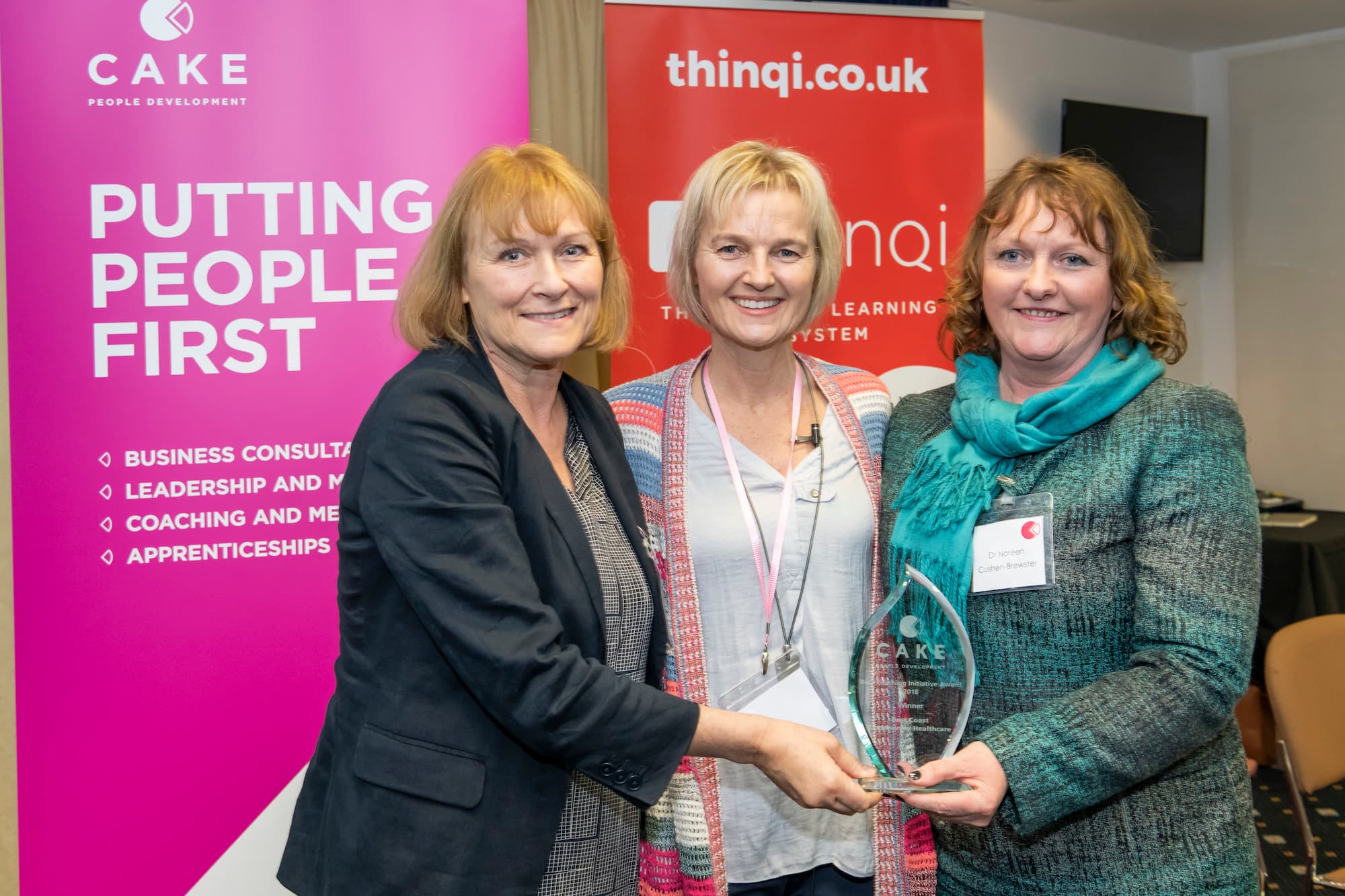 3 staff members presenting an award won at CAKE