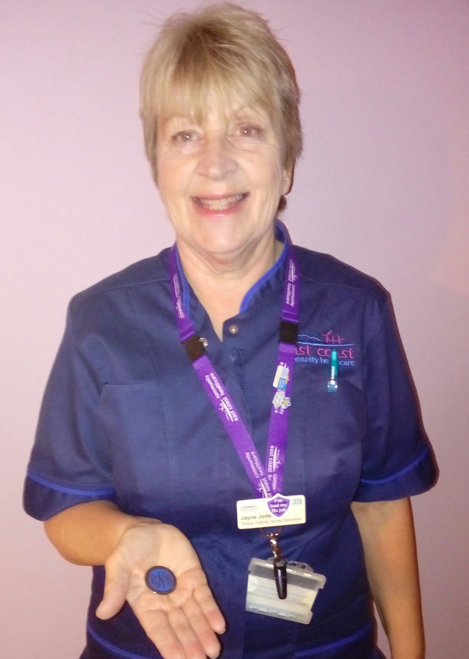 Tissue Viability Specialist Nurse Jayne Jode presenting the Chief Nursing Officer's Silver Award she had been awarded.