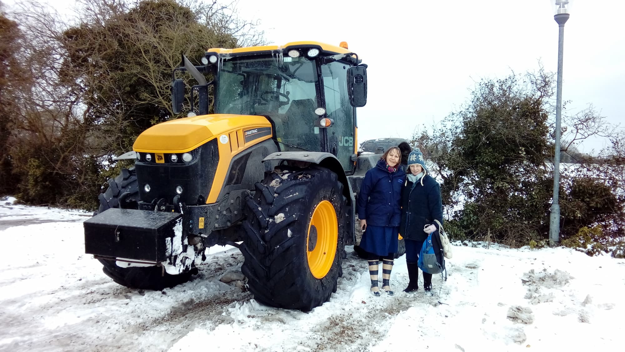 Nurse commuting to her patients in a large tractor