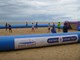 Young people playing football on Lowestoft beach inside the inflatable football pitch with ECCH and sentinel logos printed