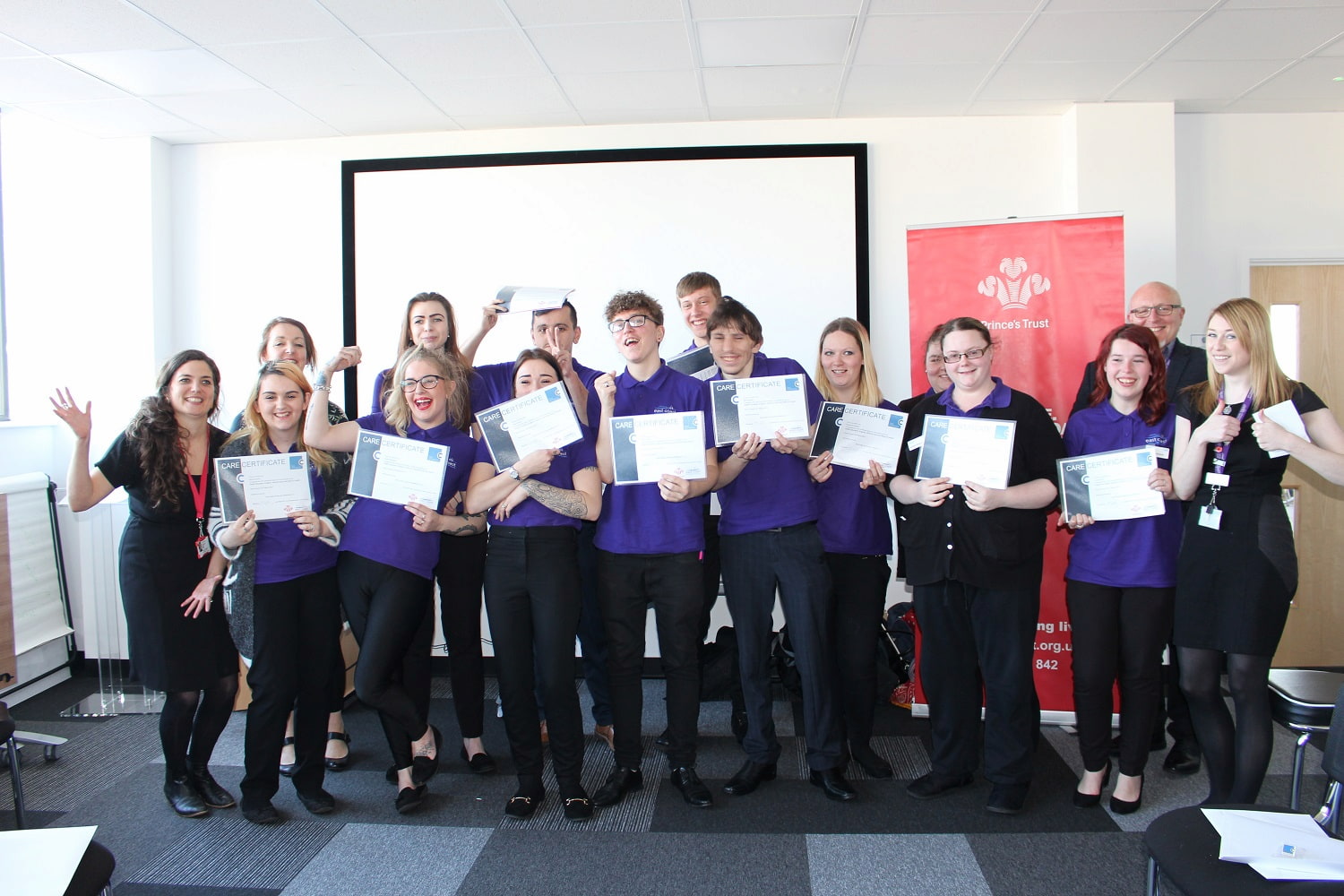 Princes Trust trainees posing for picture holding certificates