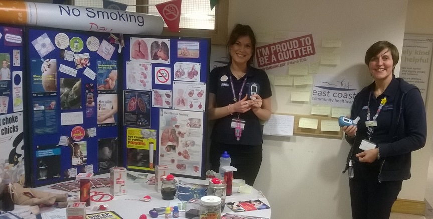 Two stop smokign advisors posing infrom of a promotional stand for No Smoking Day 2016